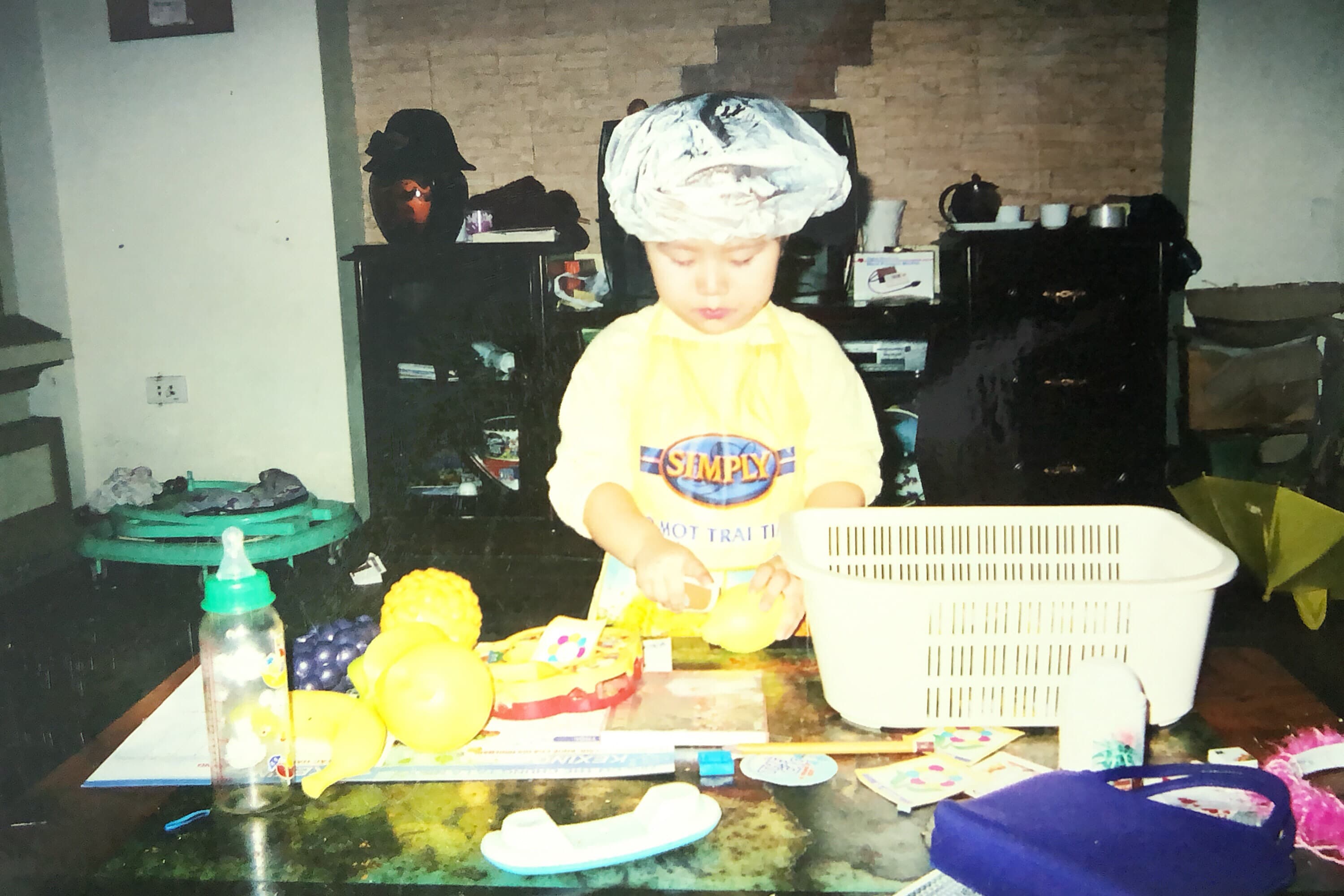 Toddler in a chef hat cooking, Hanoi